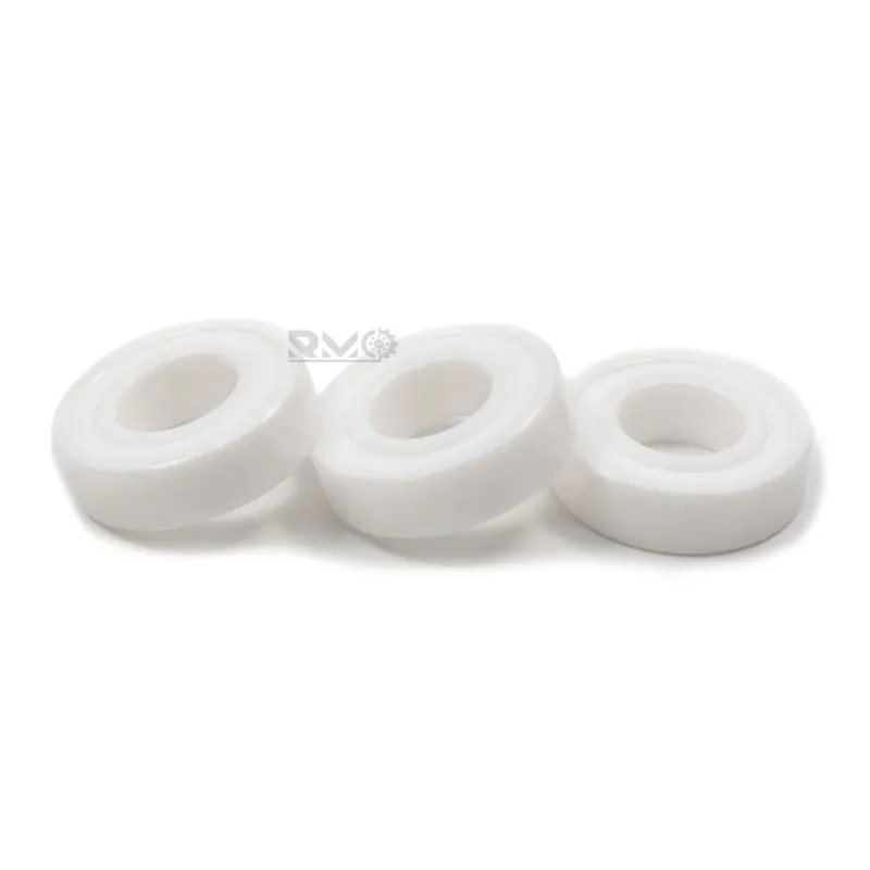 Close-up of white ZrO2 ceramic rings and dual PTFE seals on 6003CE2RS bearing